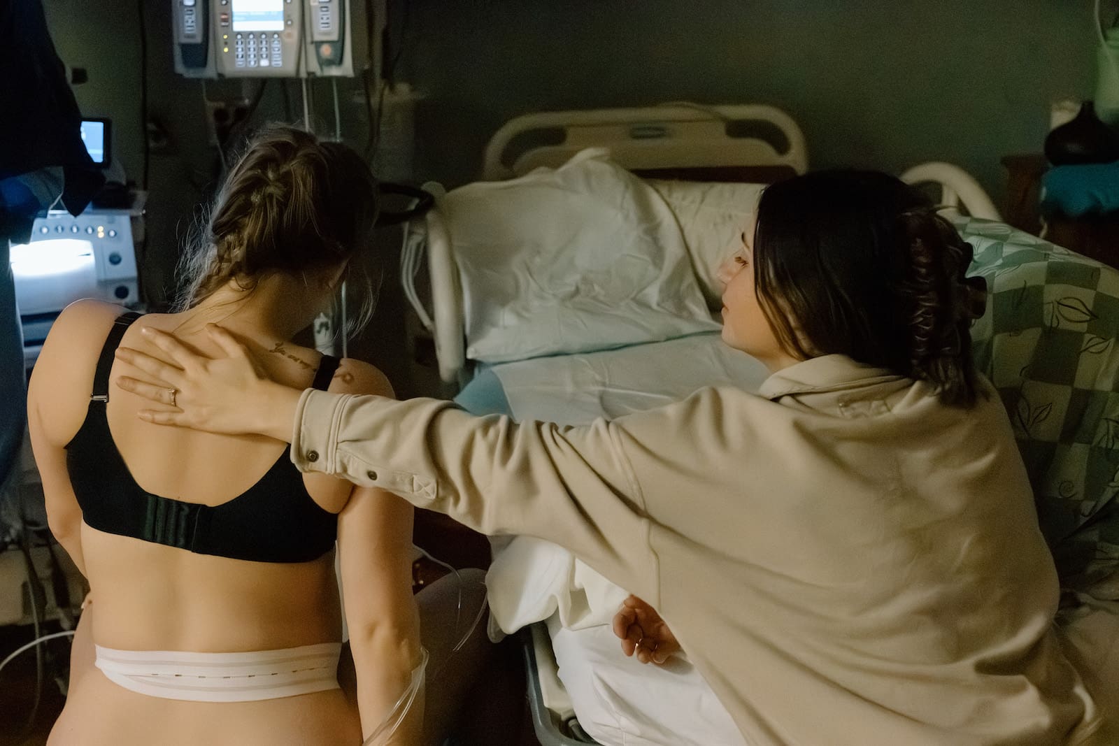 Birth doula providing hands-on labor support to a mother during childbirth in Charlotte, NC
