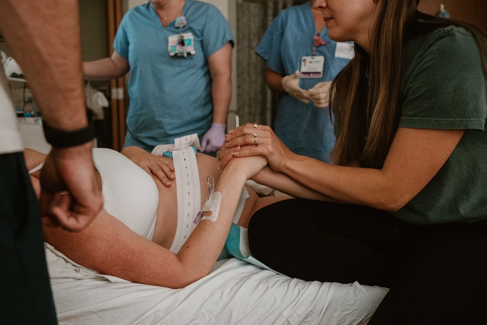 Birth doula providing hands-on labor support to an expecting mother in Charlotte, NC